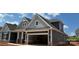 Side view of the home displaying gray siding and an open garage at 1110 Sugar Creek Rd, Indian Land, SC 29707
