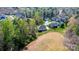 Aerial view of a residential area showcasing tree-lined streets and spacious homes surrounded by greenery at 112 Whitman Ct # 275, Taylorsville, NC 28681