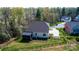 Aerial view of the home's backyard featuring a fenced yard, screened-in porch, and professional landscaping at 112 Whitman Ct # 275, Taylorsville, NC 28681
