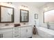A well-lit bathroom features double sinks, granite counters, a soaking tub, and modern fixtures at 112 Whitman Ct # 275, Taylorsville, NC 28681