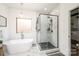 Bright bathroom featuring a soaking tub, glass enclosed shower with unique floor and stylish fixtures at 112 Whitman Ct # 275, Taylorsville, NC 28681