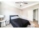 Bedroom featuring tray ceilings, a ceiling fan, comfortable bed, bedside tables and wood look floors at 112 Whitman Ct # 275, Taylorsville, NC 28681