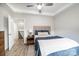 Cozy bedroom featuring a comfortable bed, ceiling fan, and a doorway leading to another room at 112 Whitman Ct # 275, Taylorsville, NC 28681