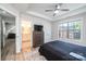 Well-lit bedroom featuring a ceiling fan, a view into an en-suite bath and wood look flooring at 112 Whitman Ct # 275, Taylorsville, NC 28681