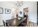 A dining room featuring a dark wood table with six chairs beneath a decorative chandelier with views to other rooms at 112 Whitman Ct # 275, Taylorsville, NC 28681