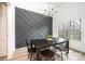 This dining room features a modern accent wall and a chandelier, creating an inviting space for gatherings at 112 Whitman Ct # 275, Taylorsville, NC 28681