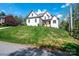 Beautiful two-story brick home on a landscaped hill featuring a manicured front yard and inviting entrance at 112 Whitman Ct # 275, Taylorsville, NC 28681