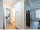 Bright hallway featuring access to a full bathroom and bedroom with neutral walls and light, wood-look floors at 112 Whitman Ct # 275, Taylorsville, NC 28681