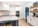 Modern kitchen features stainless appliances, white cabinets and subway tile backsplash, plus a central island with granite countertops at 112 Whitman Ct # 275, Taylorsville, NC 28681