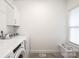 Well-lit laundry room with modern appliances, white cabinetry, and a window for natural light at 112 Whitman Ct # 275, Taylorsville, NC 28681