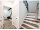 A staircase features wooden steps with white risers and a dark wooden railing for a classic look at 112 Whitman Ct # 275, Taylorsville, NC 28681