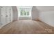 Bright bedroom with a large window letting in light, featuring beautiful wood floors at 117 Wrenwood Ln, Charlotte, NC 28211