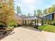 Stunning covered driveway with beautiful brickwork and manicured landscaping at 117 Wrenwood Ln, Charlotte, NC 28211