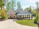 Striking exterior of home featuring mature landscaping and a covered drive at 117 Wrenwood Ln, Charlotte, NC 28211