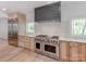 Gourmet kitchen featuring Wolf range, stainless steel appliances, and custom cabinets at 117 Wrenwood Ln, Charlotte, NC 28211