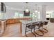 Bright kitchen featuring a center island with seating, modern fixtures, and open design at 117 Wrenwood Ln, Charlotte, NC 28211