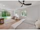Bright main bedroom with pool view, white walls and ceiling fan at 117 Wrenwood Ln, Charlotte, NC 28211