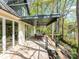 Covered outdoor dining area with ceiling fans and lake views from the upper deck at 117 Wrenwood Ln, Charlotte, NC 28211