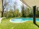 Backyard pool surrounded by lush landscaping, perfect for relaxation at 117 Wrenwood Ln, Charlotte, NC 28211