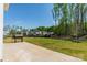 Expansive backyard with a concrete patio, lush green grass, black fencing and bordered by mature trees at 12526 Dunloe Wood Dr, Huntersville, NC 28078
