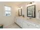Bright bathroom featuring double sinks, white cabinets, and a large mirror for enhanced appeal at 12526 Dunloe Wood Dr, Huntersville, NC 28078