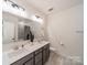 Bright bathroom with a dual sink vanity and a shower-over-tub combination at 12526 Dunloe Wood Dr, Huntersville, NC 28078