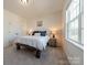 Bedroom with neutral walls, plush carpet, and natural light from a bright window at 12526 Dunloe Wood Dr, Huntersville, NC 28078