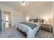 Well-lit bedroom with neutral decor, plush carpet, and adjacent walk-in closet at 12526 Dunloe Wood Dr, Huntersville, NC 28078
