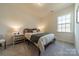 Cozy bedroom with a comfortable bed, natural light, and neutral decor for a relaxing atmosphere at 12526 Dunloe Wood Dr, Huntersville, NC 28078