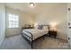 Comfortable bedroom with neutral walls, plush carpet, and natural light from a bright window at 12526 Dunloe Wood Dr, Huntersville, NC 28078