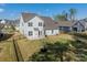 The home's exterior elevation exhibits a well-maintained lawn, fenced yard, and pleasing facade at 12526 Dunloe Wood Dr, Huntersville, NC 28078