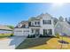 Attractive two-story home featuring a three-car garage, black shutters, and manicured landscaping at 12526 Dunloe Wood Dr, Huntersville, NC 28078