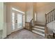 Bright foyer featuring a decorative glass front door, stairs and trim carpentry at 12526 Dunloe Wood Dr, Huntersville, NC 28078