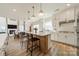 Bright, open-concept kitchen with a large island, white cabinetry, and seamless flow into the dining area at 12526 Dunloe Wood Dr, Huntersville, NC 28078