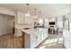 Beautiful kitchen with white cabinets, a spacious island, and seamless flow into the dining and living area at 12526 Dunloe Wood Dr, Huntersville, NC 28078