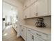 Gourmet kitchen featuring white cabinets, quartz countertops, and a herringbone tile backsplash at 12526 Dunloe Wood Dr, Huntersville, NC 28078