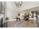 Open-concept living room featuring a large chandelier, fireplace, and seamless flow into the kitchen and foyer at 12526 Dunloe Wood Dr, Huntersville, NC 28078