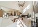 Bright open-concept living room showcasing a comfortable white sofa, stylish rug, and seamless kitchen access at 12526 Dunloe Wood Dr, Huntersville, NC 28078