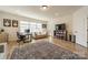 Bright room featuring a desk, couch, tv, and built in shelving providing a comfortable and functional space at 12526 Dunloe Wood Dr, Huntersville, NC 28078