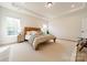 Bright main bedroom featuring two windows, and a wooden accent bed with an ensuite bathroom at 12526 Dunloe Wood Dr, Huntersville, NC 28078