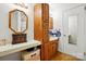 A cozy bathroom featuring a sink and vanity with blue patterned tiling, as well as a wooden cabinet for storage at 140 Oak Ave, Mount Holly, NC 28120