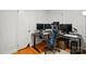 This bedroom is currently utilized as an office space, and features hardwood floors, a ceiling fan, and a spacious desk area at 140 Oak Ave, Mount Holly, NC 28120