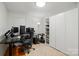 This bedroom is currently utilized as an office space, and features a large closet and a spacious desk area at 140 Oak Ave, Mount Holly, NC 28120