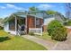 Exterior view of the home featuring brick accents, a covered porch, and a well-maintained yard at 140 Oak Ave, Mount Holly, NC 28120