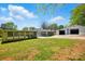 Exterior of home with large detached garage and sunroom on a spacious lot at 140 Oak Ave, Mount Holly, NC 28120