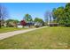 Charming single-story home with a well-manicured lawn, carport, and a welcoming driveway at 140 Oak Ave, Mount Holly, NC 28120