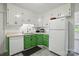 Bright kitchen with stainless steel appliances and green cabinets at 140 Oak Ave, Mount Holly, NC 28120