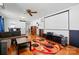 Bright living room featuring a colorful rug, projector screen, hardwood floors and comfortable seating at 140 Oak Ave, Mount Holly, NC 28120