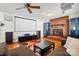 Spacious living room featuring a brick fireplace, projector screen, and hardwood floors at 140 Oak Ave, Mount Holly, NC 28120
