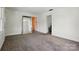 Bright living room featuring carpet, large windows, and a full-length mirror at 140 Oak Ave, Mount Holly, NC 28120